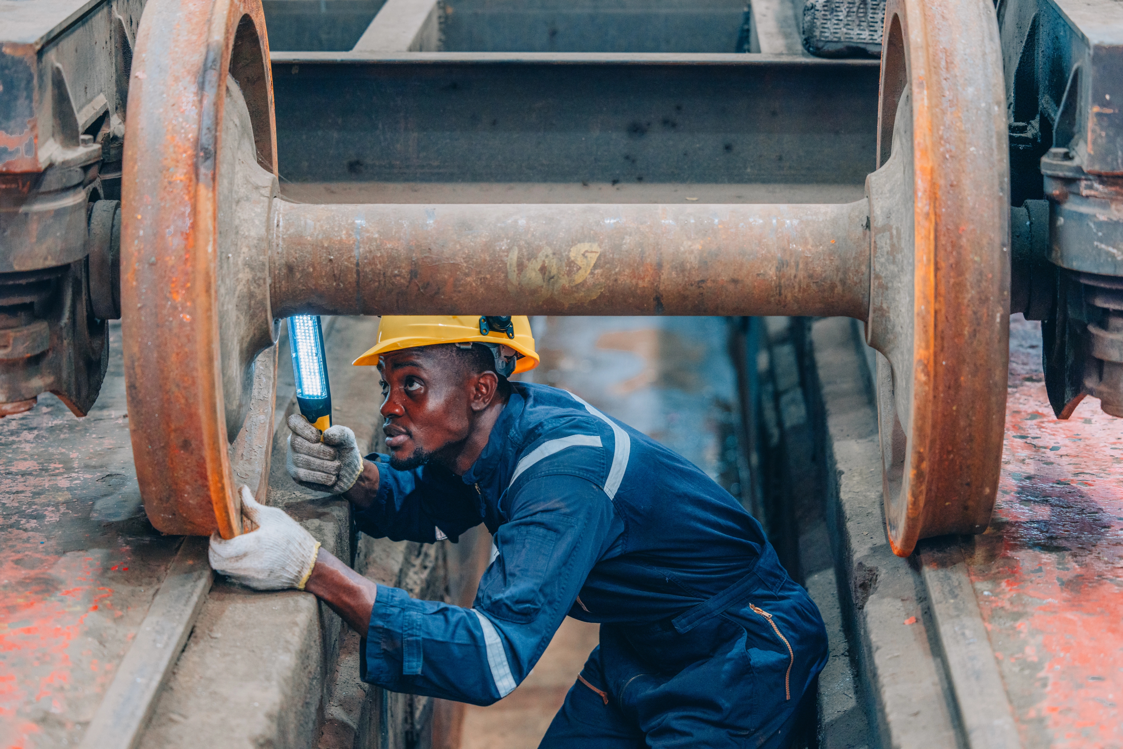 An image of an engineer working on an industrial pipe
